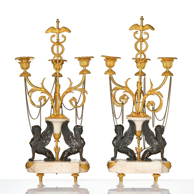 A pair of Louis XVI three lights Candelabra, Parisian works, in the manner of François Rémond, late 18th century.