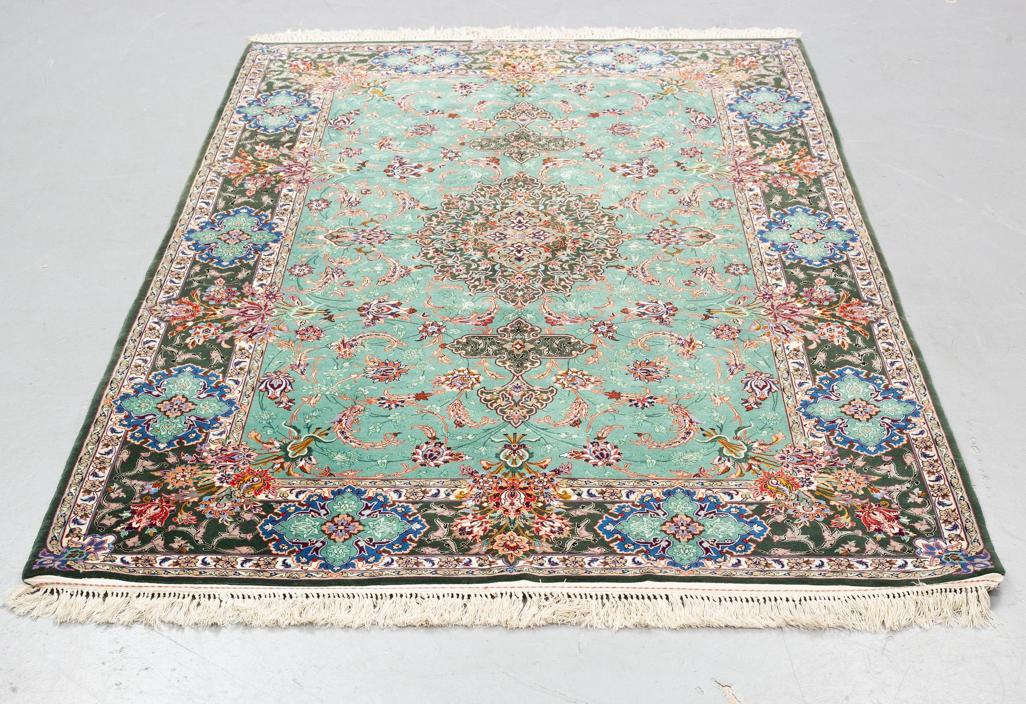 A rug, old Esfahan, part silk, signed, ca 225 x 149 cm (ca 1,5-2,5 cm flat weave at the ends).