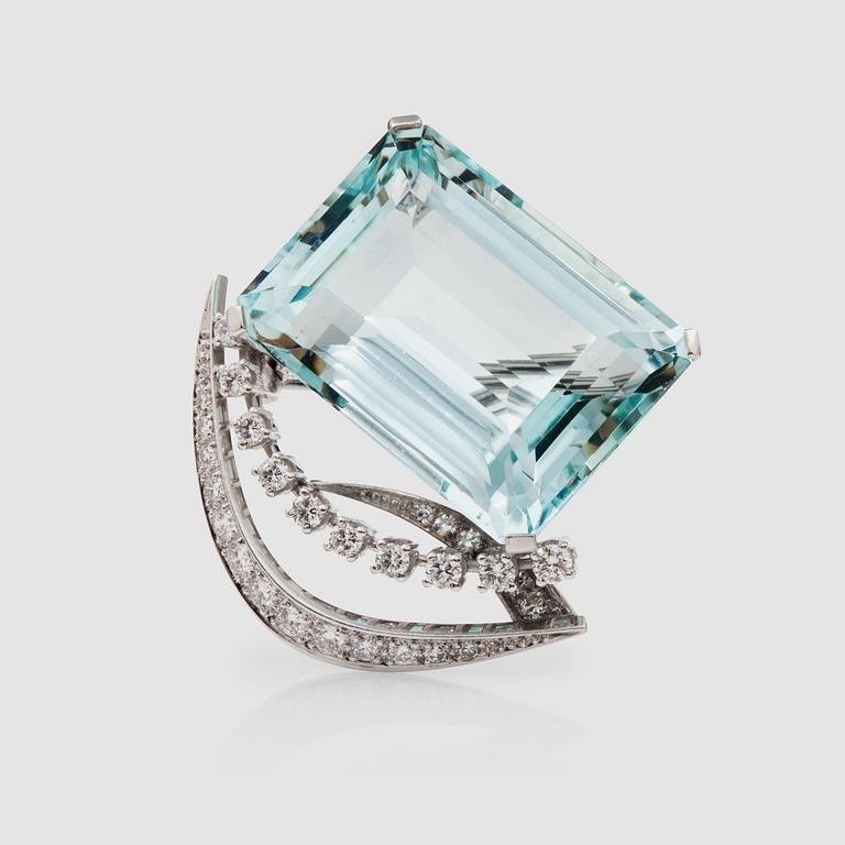 A aquamarine, circa 31.00 cts, and diamond, total carat weight circa 0.60 ct, brooch.