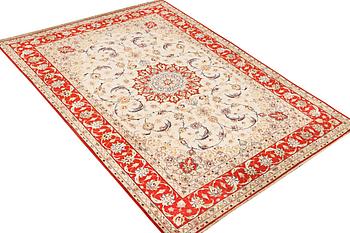 A semi-antique part silk Isfahan rug, a. 238 x 156 cm.