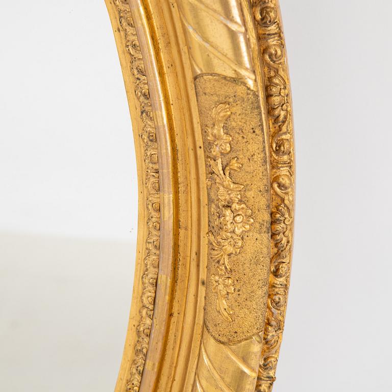 An oval mirror from around the year 1900.