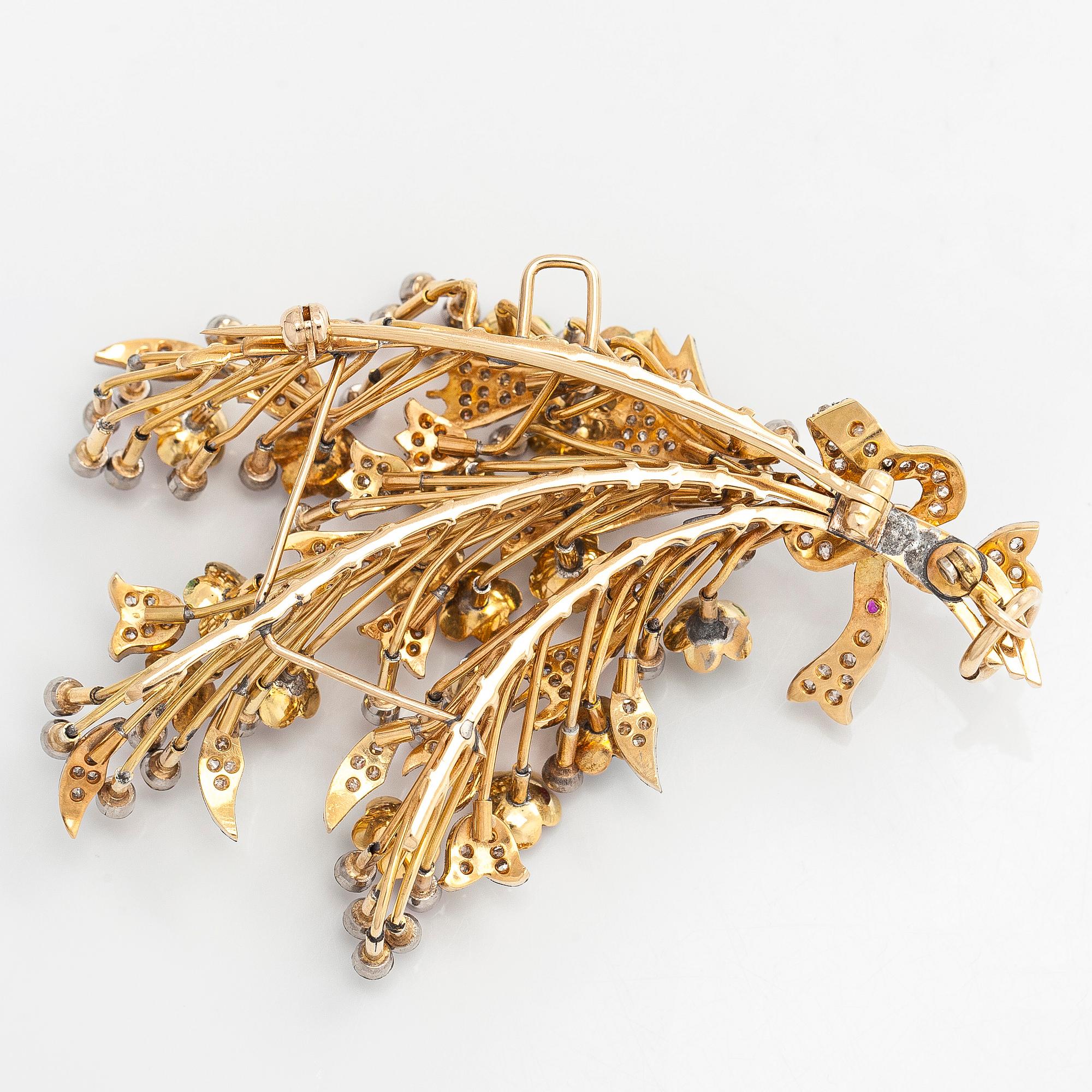 A 17K gold brooch/pendant with rose-cut diamonds, cabochon-cut rubies and enamel.