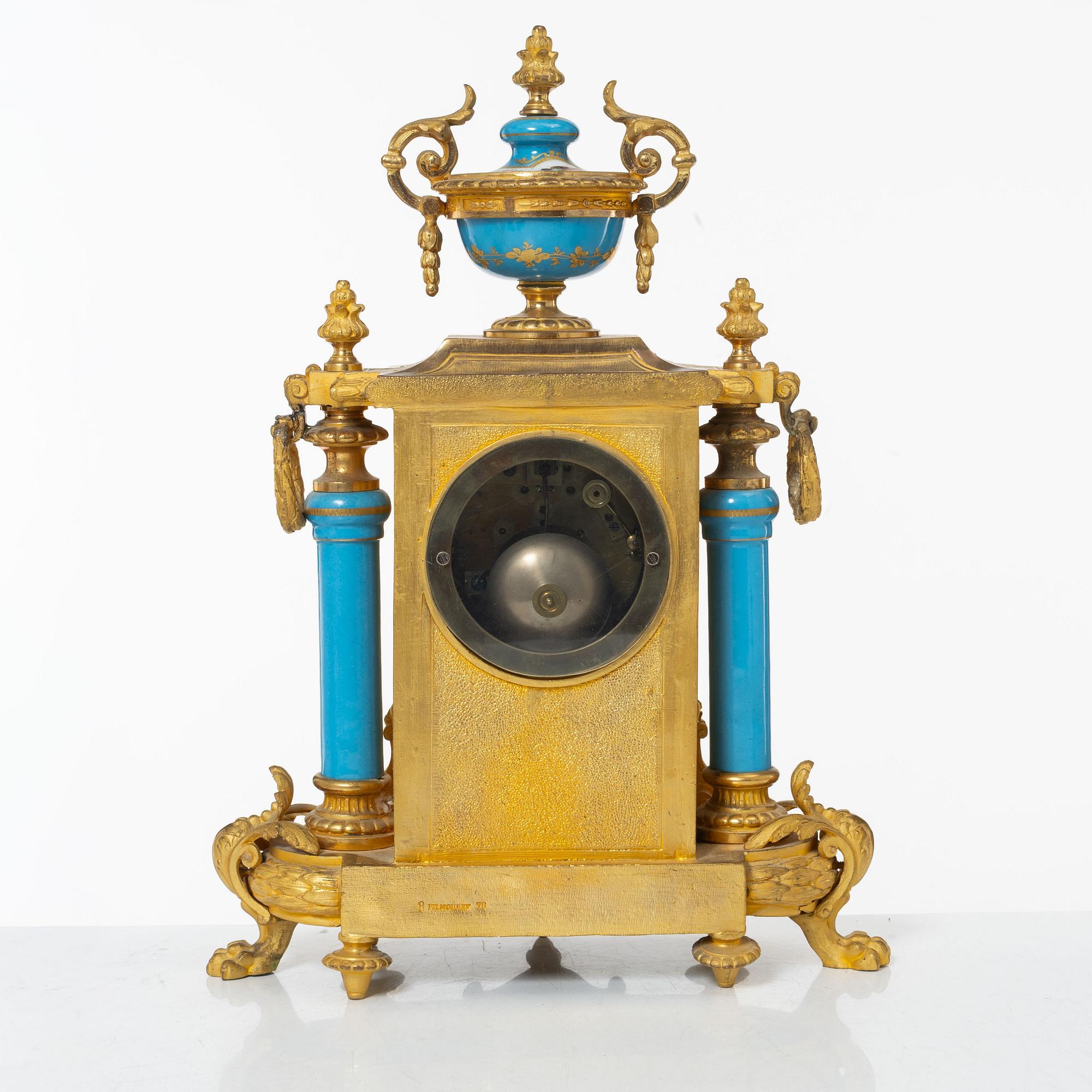 A French Louis XVI-style mantel clock and a pair of candelabra, late 19th Century.