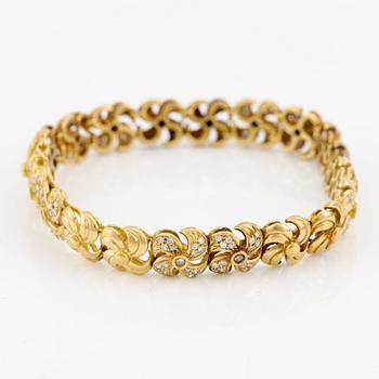 Armlänk, 18K guld med briljantslipade diamanter.