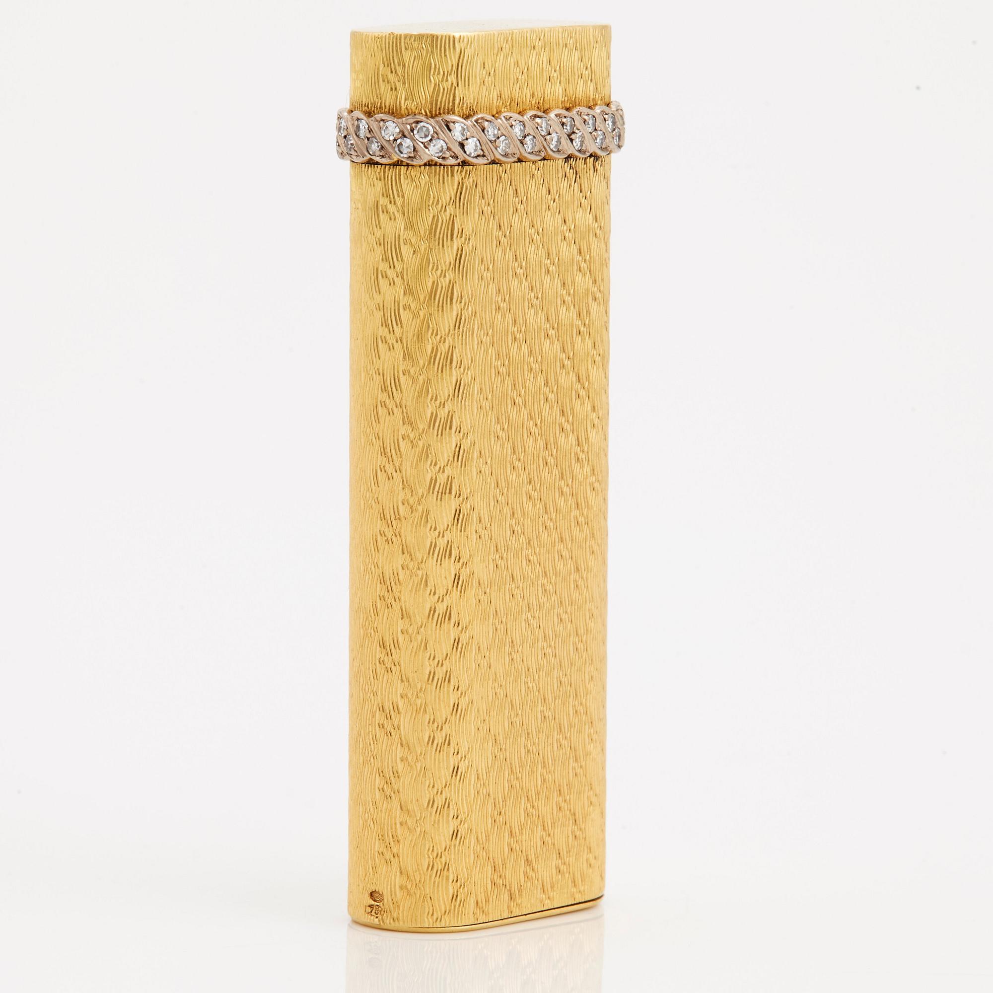 A cigarette lighter by Cartier set with single cut diamonds.