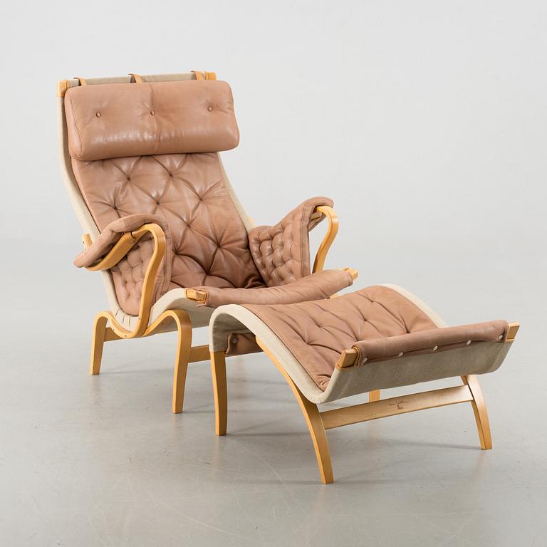 A "PERNILLA" ARMCHAIR WITH OTTAMAN BY BRUNO MATHSSON BY DUX.