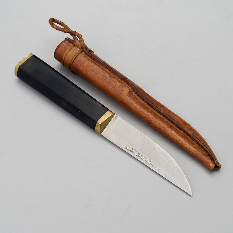 A Finnish puukko knife in stainless steel, nylon and brass designed by Tapio Wirkkala, Hackman Finland.