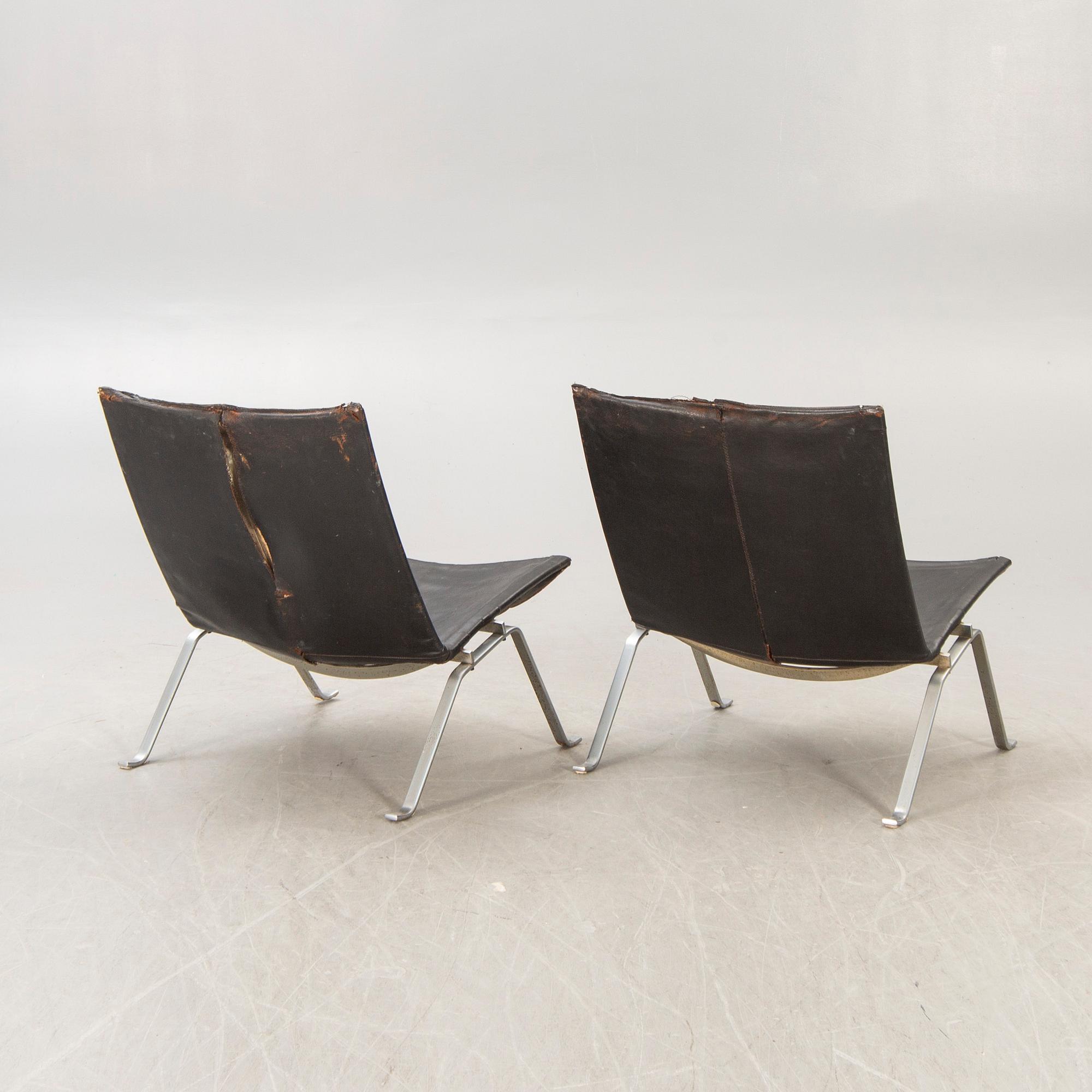 A pair of Poul Kjaerholm metal and leather PK22 easy chairs from Kold Christensen Denmark.