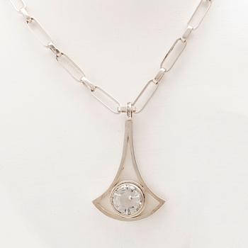 A silver necklace set with a round faceted rock quartz crystal by Göran Kuhlin Gothenburg 1971.