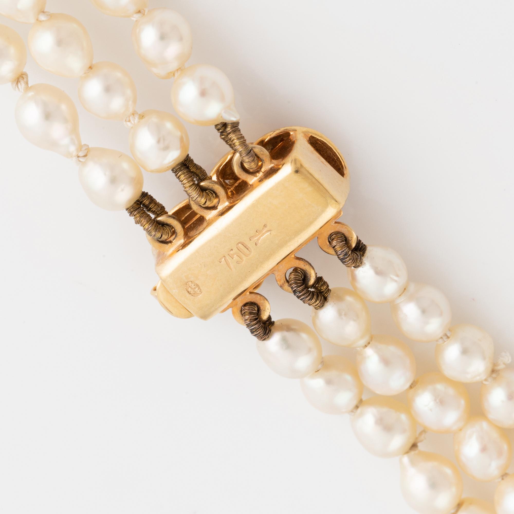 Cultured three strand pearl necklace. Clasp 18K gold.