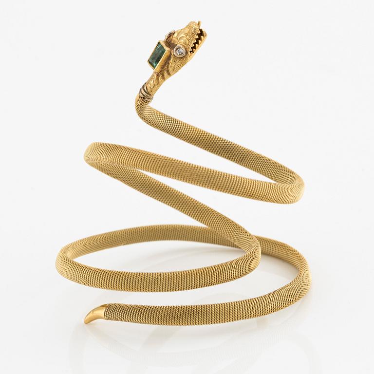 An 18K gold snake bracelet with an emerald and eight-cut diamonds.