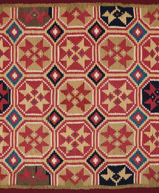 A CARRIAGE CUSHION, double-interlocked tapestry, "Stjärnmönster", ca 43,5-44,5 x 94-95 cm, Scania (Sweden).