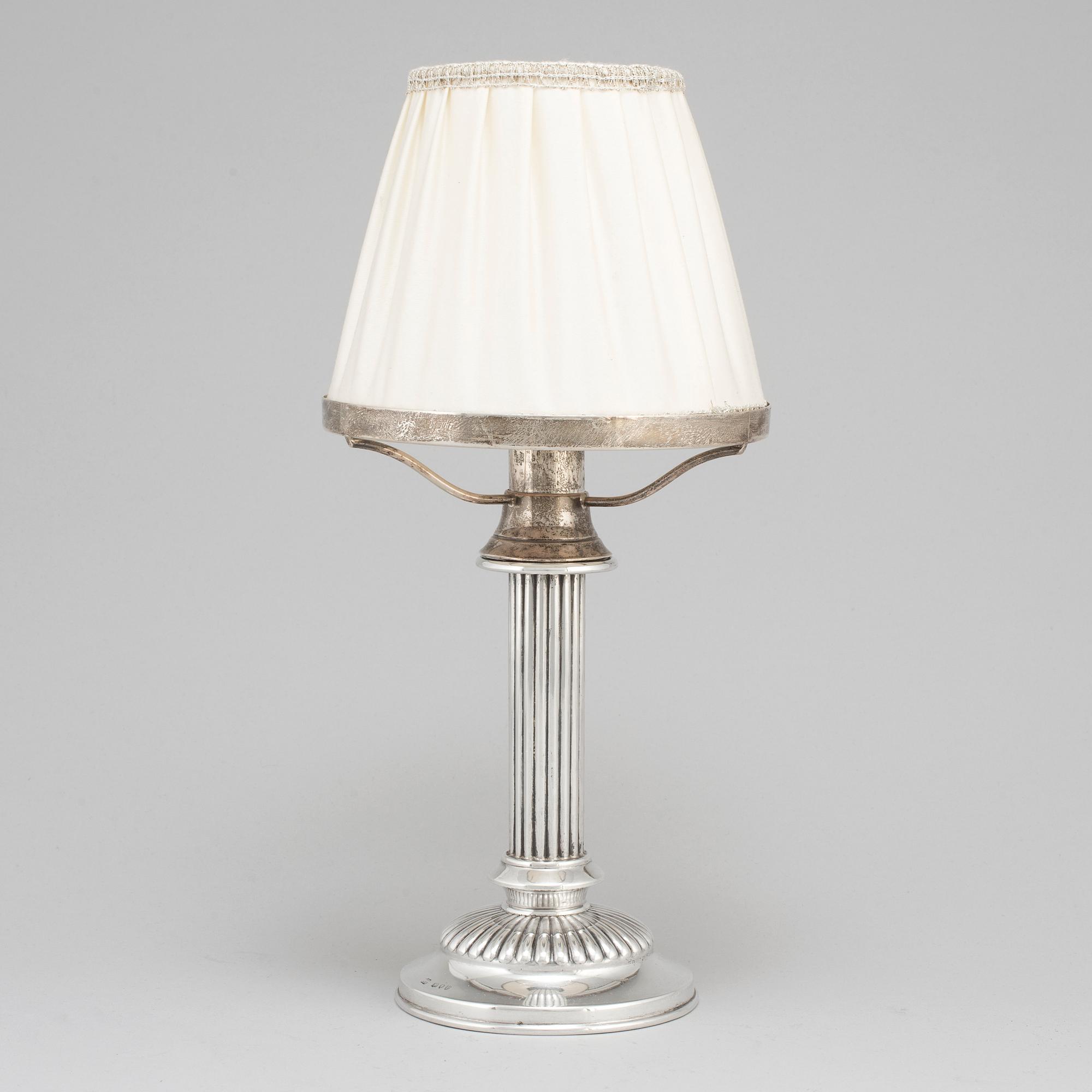 An English 19th century silver candlestick and shade, mark of London 1890.