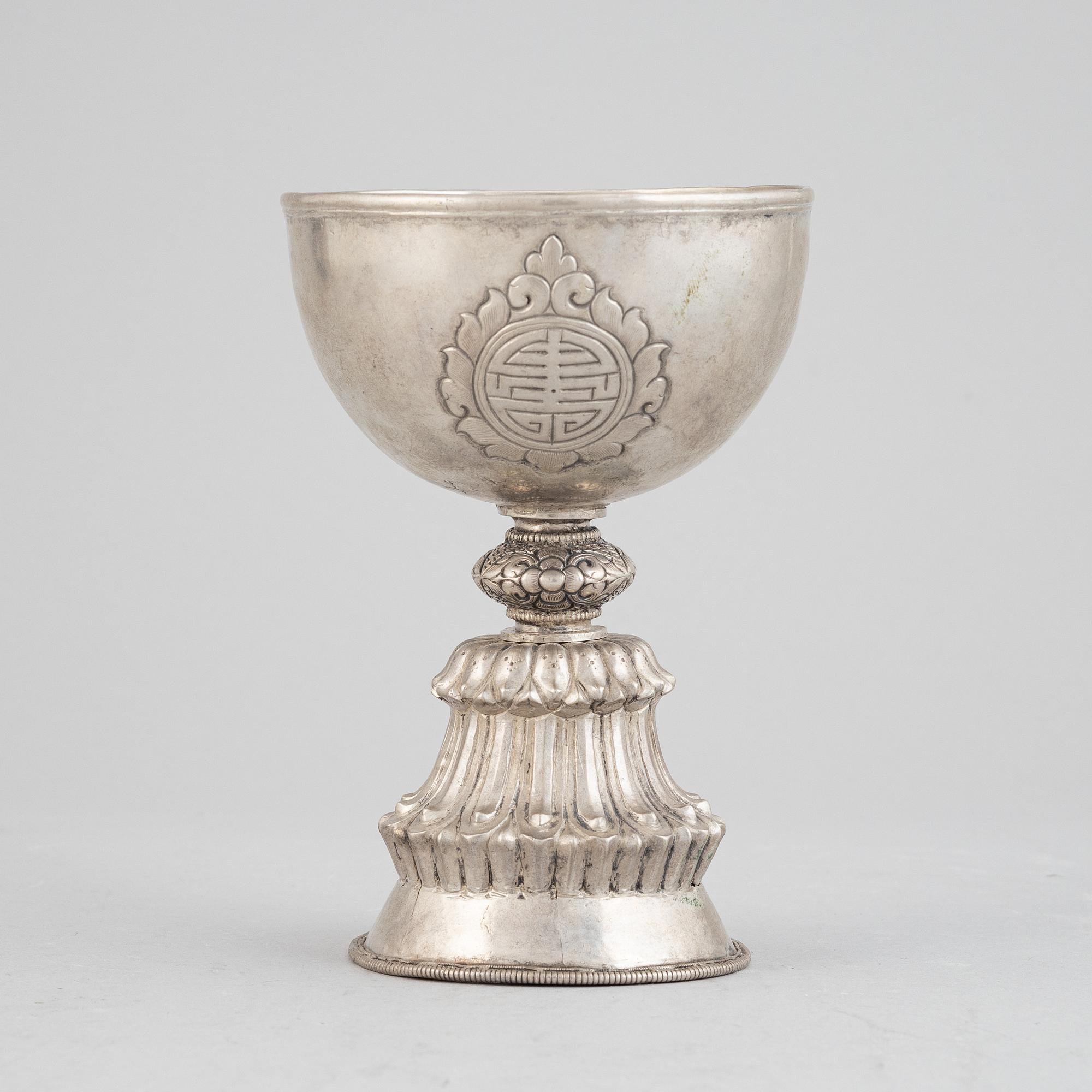 A Tibetan butter lamp, silvered copper, 20th century.