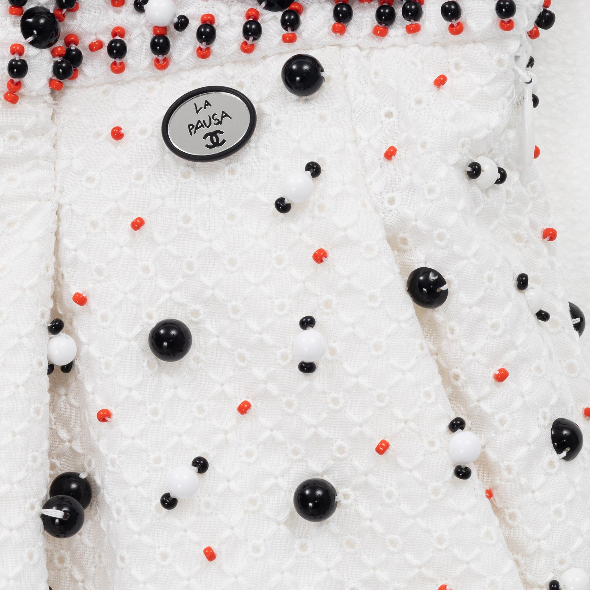 Chanel, a pair of broderie anglais trousers with pearls, size 34.