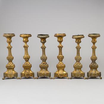 Six late 18th century brass candlesticks.