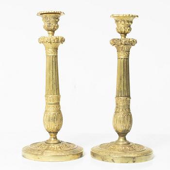 A pair of bronze candle sticks, France, first half of the/mid 19th century.