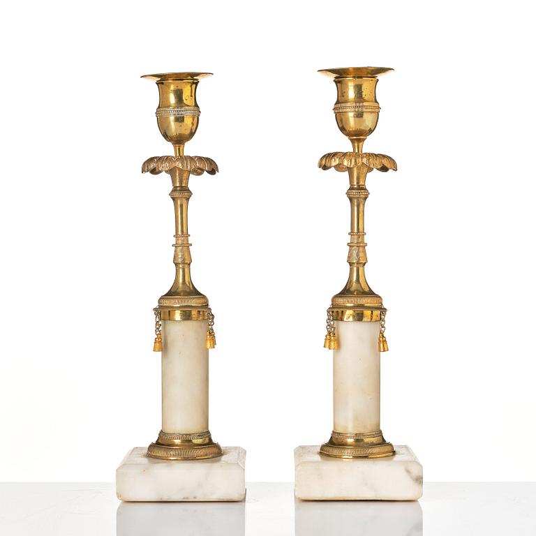 A pair of late Gustavian marble and bronze candlesticks.