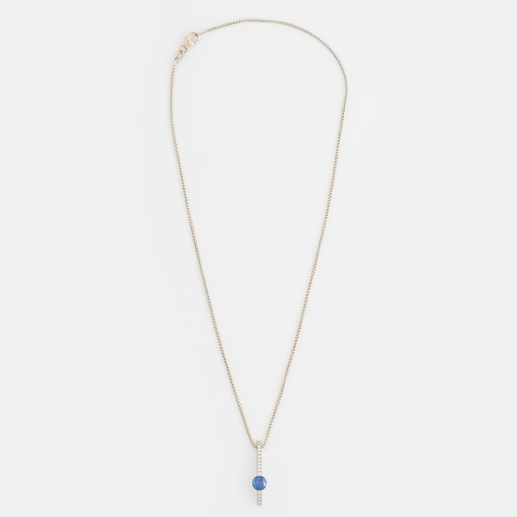 An 18K white gold necklace with a faceted sapphire.