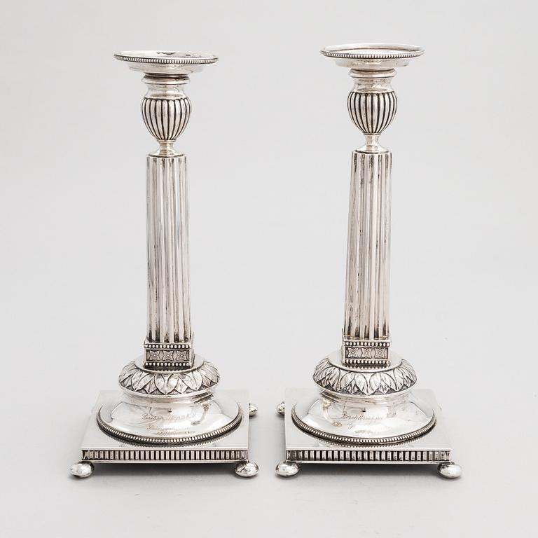 A pair of Swedish silver candlesticks, CG Hallberg, Stockholm 1901 and 1902.