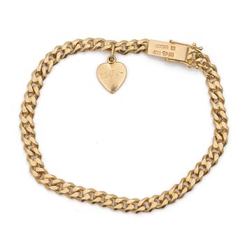 An 18K gold curb-link bracelet and a charm.