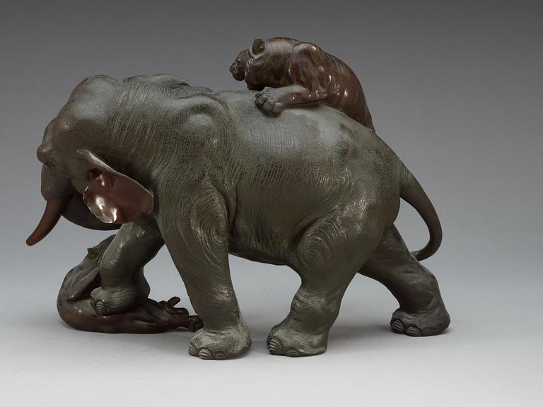 A large Japanese bronze sculpture of an elephant attacked by tigers, with seal mark, Meiji, circa 1900.