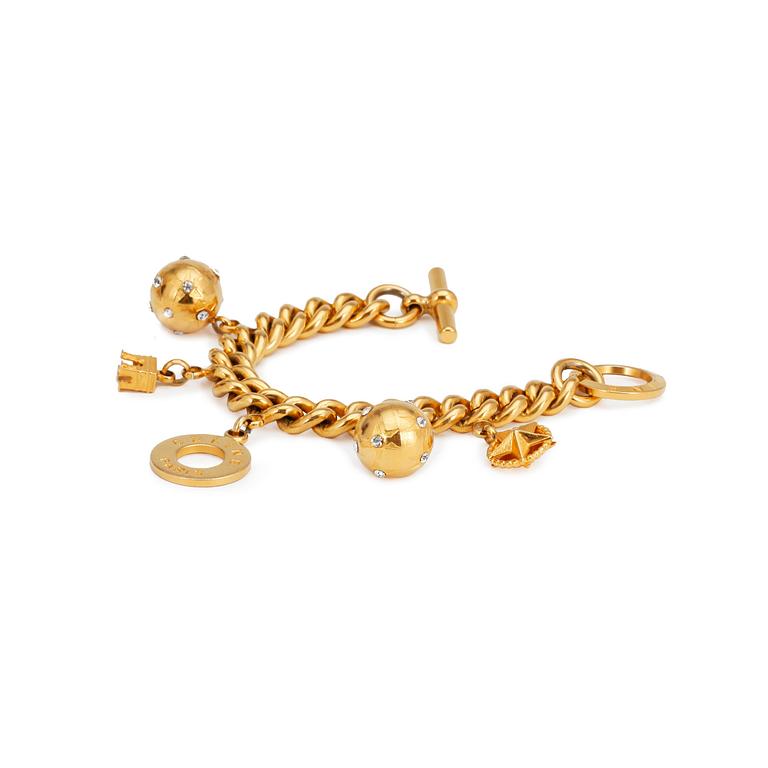 CÉLINE, a gold colored charm bracelet.