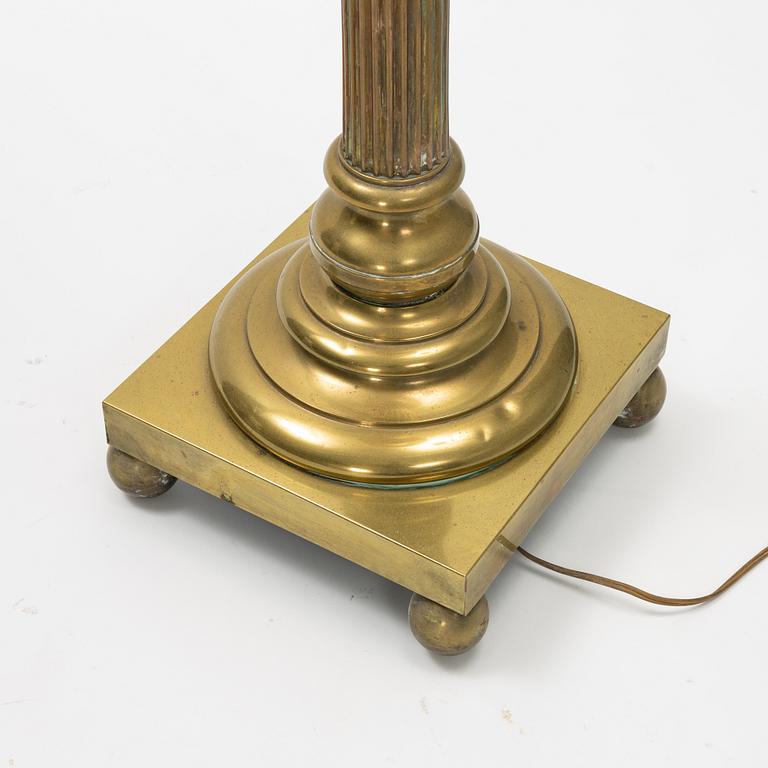 A brass floor lamp, circa 1900.
