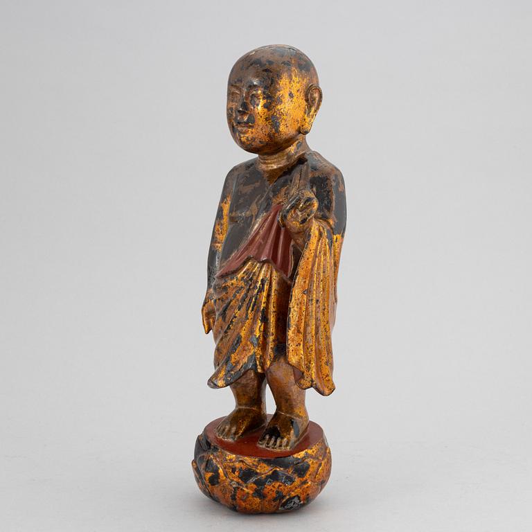 A Chinese wood gilt and lacquer sculpture of a boy, 20th Century.