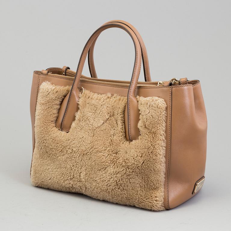 A leather and cbag by Tod'sastor.