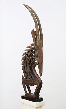 HEADDRESS. Tshiwara/Ciwara (stylized male antelope). Wooden sculpture with metal fittings.