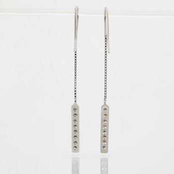 A pair of 18K white gold earrings set with round brilliant-cut diamonds.