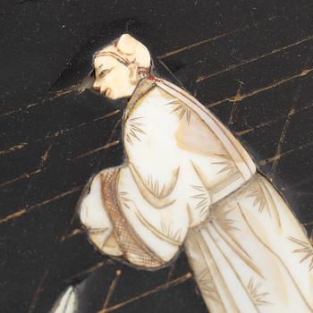 Four black-lacquered wall decorations, China, around 1900.