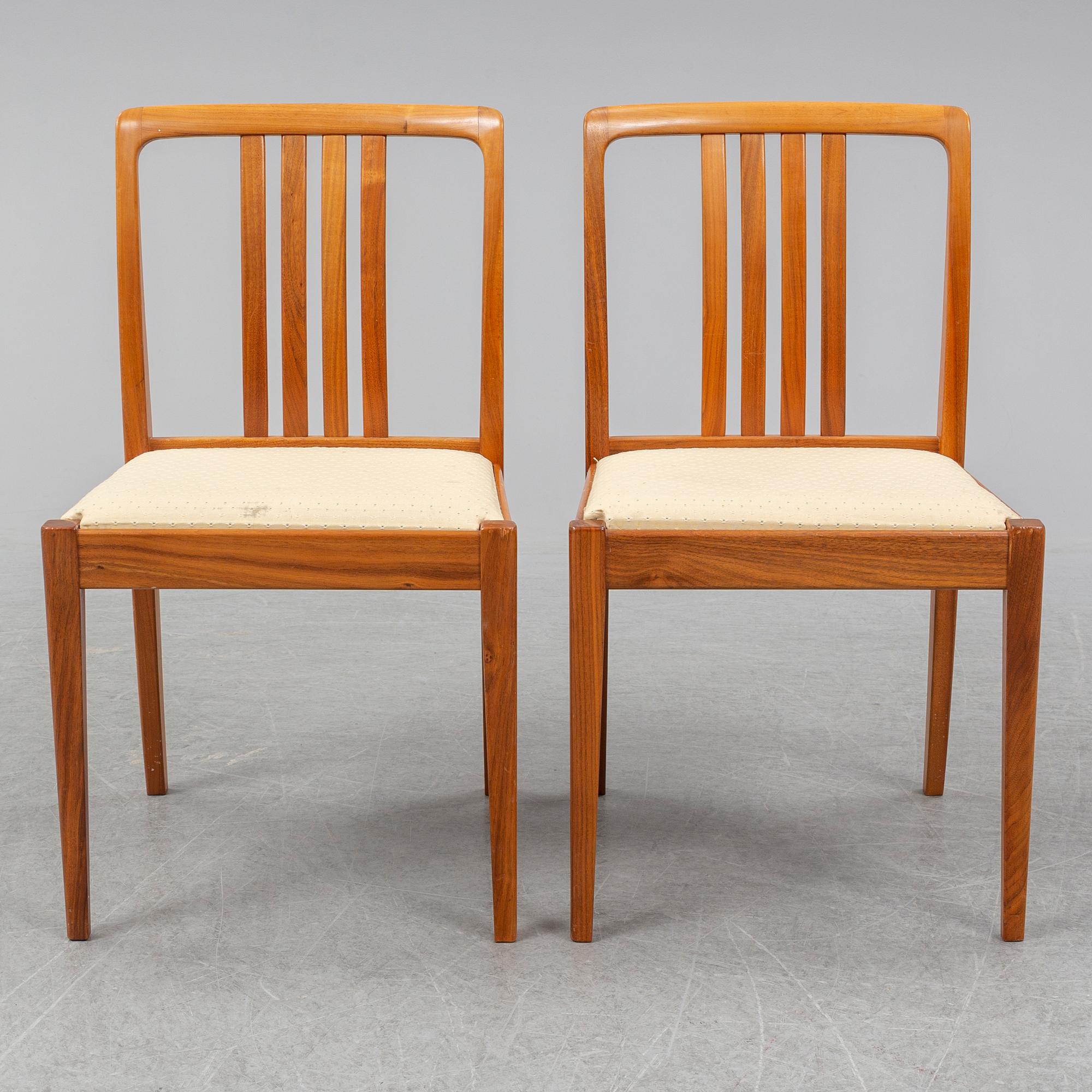 A 1950/60s teak and valnut table and four chairs.