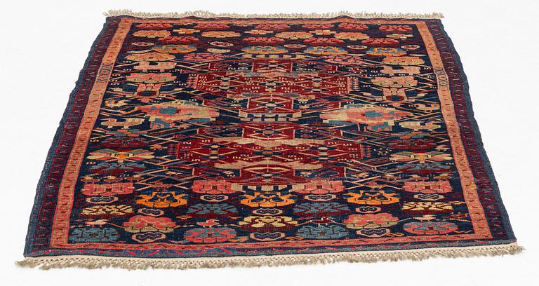 An antique Kuba rug, c. 128-133 x 103 cm.