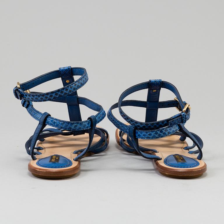 A pair of blue leather sandals by Louis Vuitton.