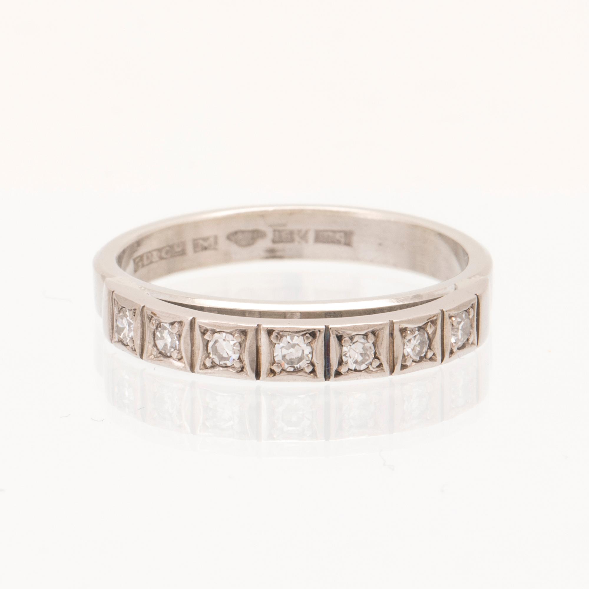 An 18K white gold ring set with round single cut dimamonds.