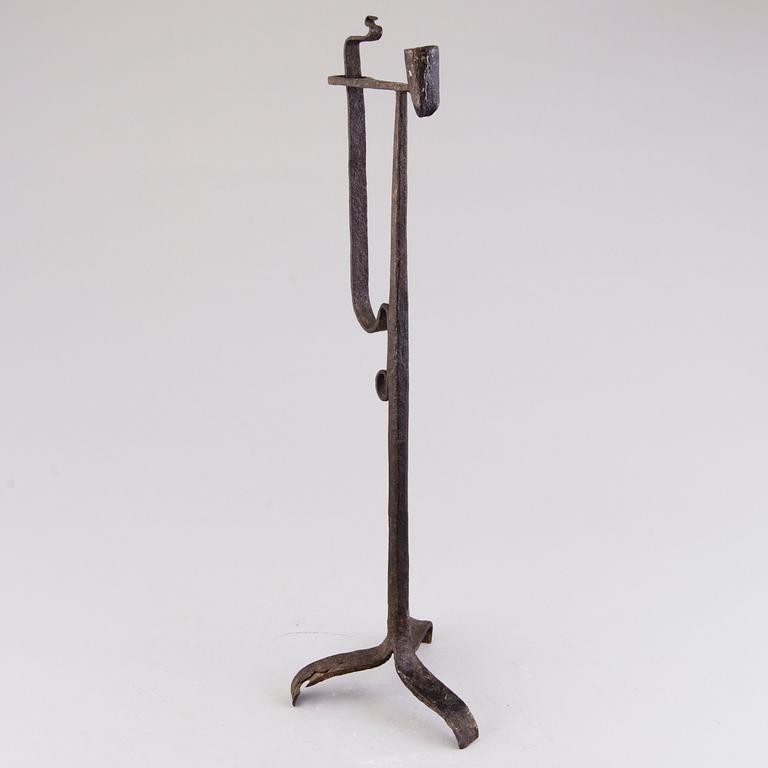 A 18th century wrought iron rush light and candle holder.