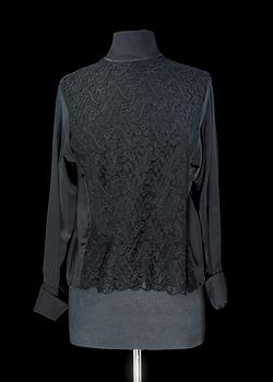 1266. A black silk lace blouse by Yves saint Laurent.