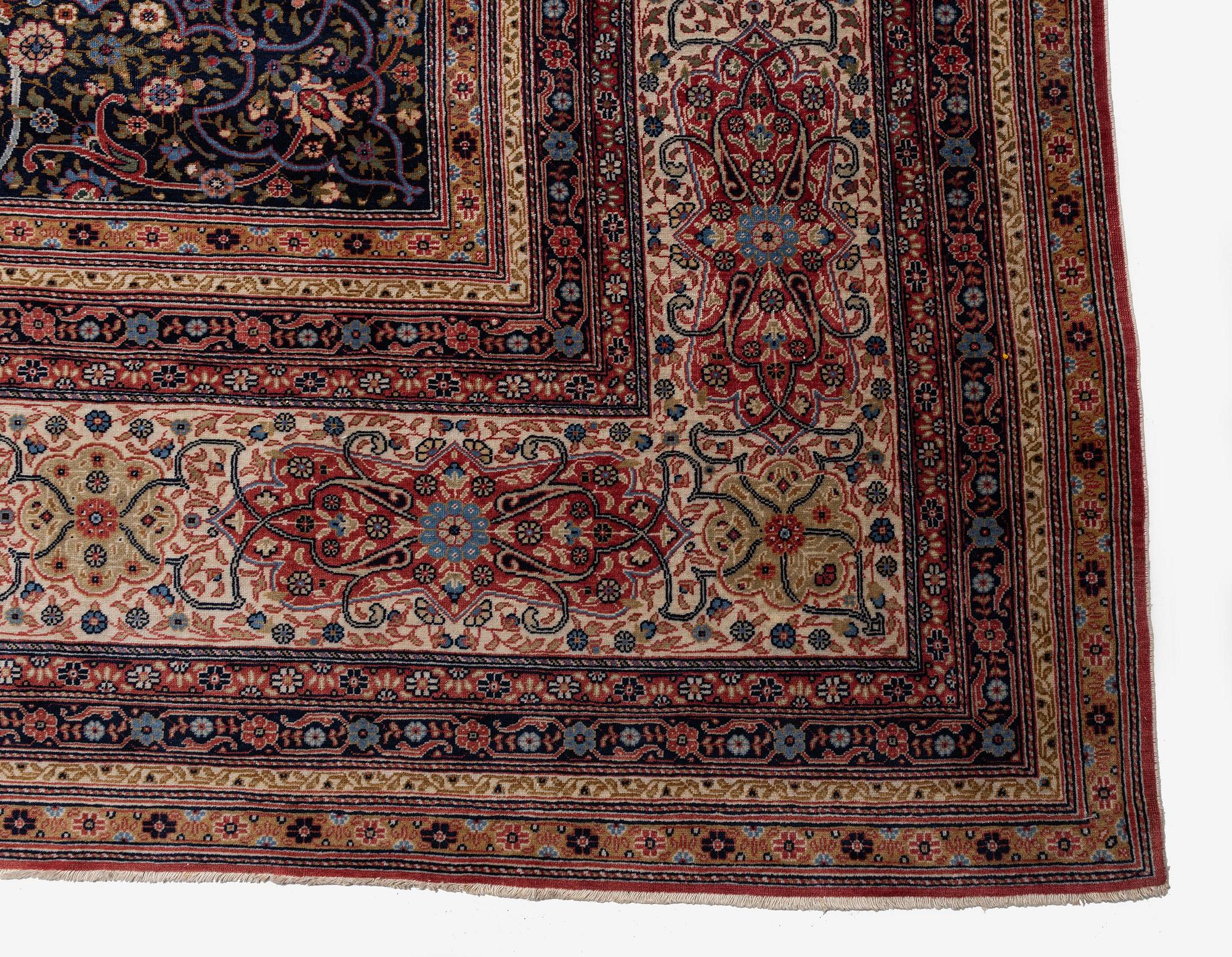 A semi-antique Hereke carpet, Western Turkey, c. 685 x 489 cm.