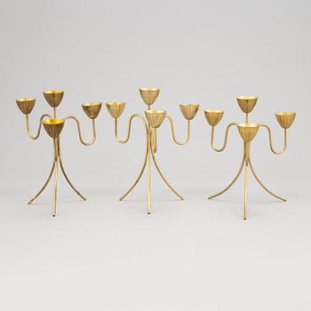 Gunnar Ander, a set of three brass five-light candelabra from Ystad Metall.