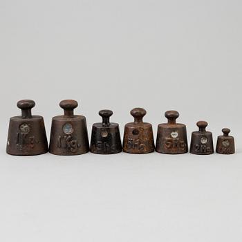 A 20th century cast iron balance with brass and iron weights, partly Skultuna, Sweden.