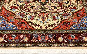 A part silk Tabriz rug, so-called 50 Raj, approx. 242 x 178 cm.