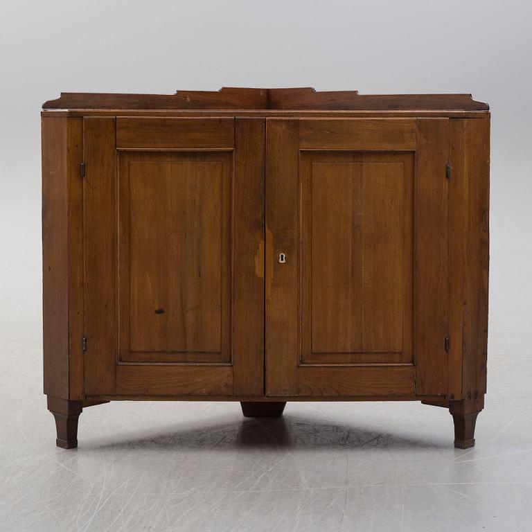 A 18th century elm cabinet for a corner.