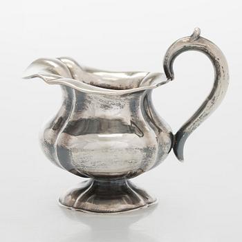 A silver cream jug, maker's mark of Michael Takkinen, St. Petersburg 1856.