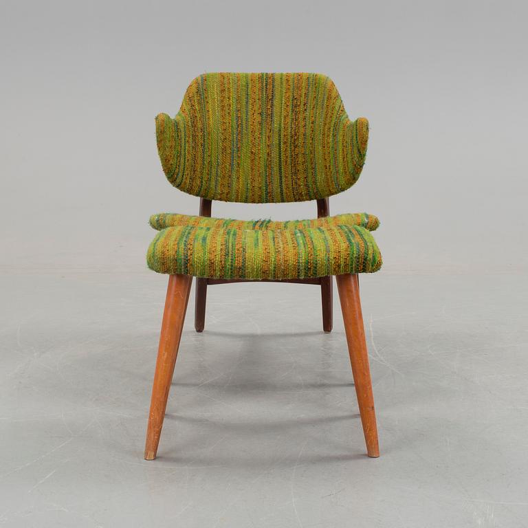 An IKEA armchair with a stool.