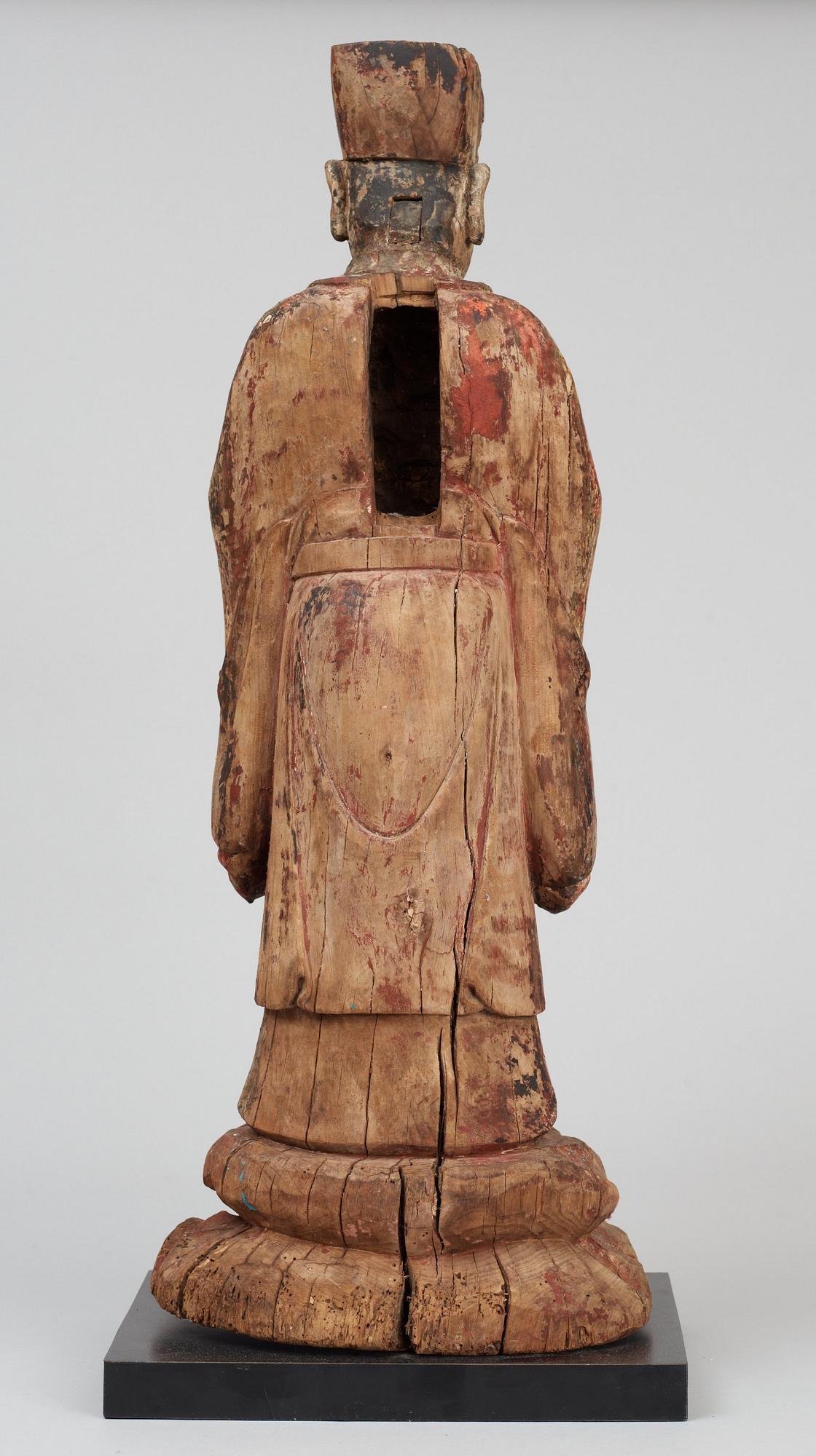 A wooden sculpture of a deity, Ming style.