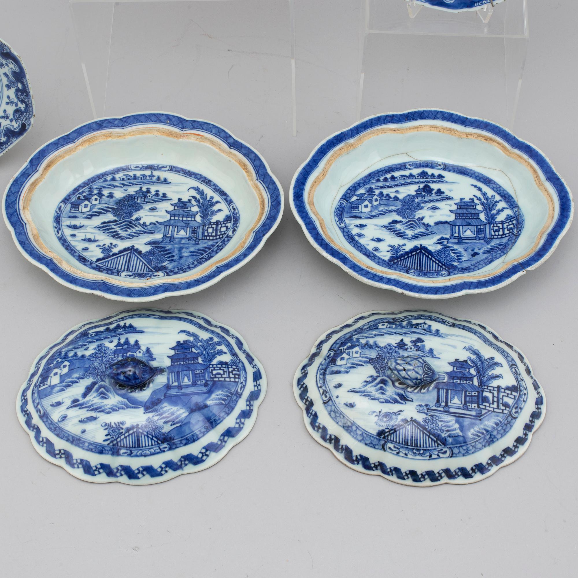 Two blue and white export porcelain tureens with covers and three dishes, Qing dynasty, 18th century.
