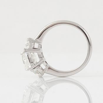 A cushion-cut diamond, 3.01 cts, flanked by two trapezoid-cut diamonds, 1.13 cts, ring.