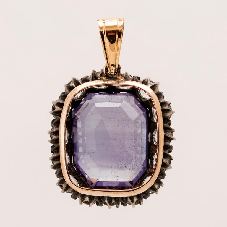 Pendant in low-grade gold and silver set with a synthetic color-changing purple sapphire, and synthetic stones.